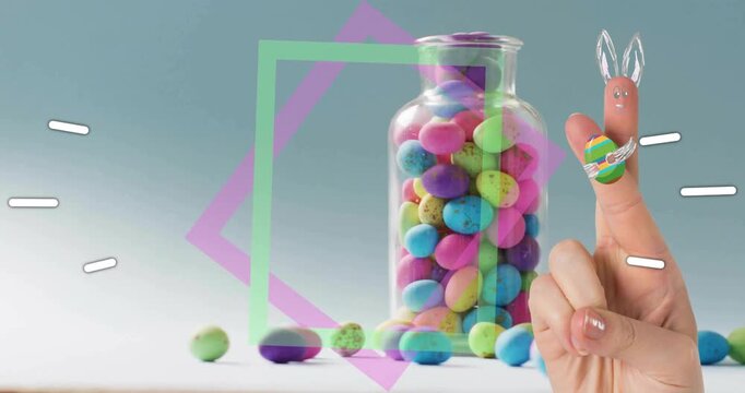 Hand entering right forming fingertip bunny, neon square rotating over pastel candy jar marketing