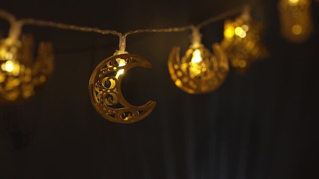 Islamic String lights. A crescent moon and stars shine above elegant Islamic calligraphy decorations