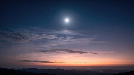Obraz premium A serene twilight sky with clouds, stars, and a bright moon over dark mountain silhouettes.