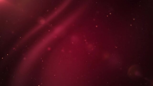 Abstract red background with shimmering particles and light streaks creates an elegant and dynamic visual