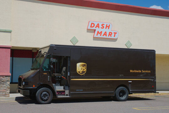 Brown UPS Delivery Truck Parked Outside Dash Mart Store Front On Sunny Day Editorial Use Only March 9, 2026, St. Petersburg,FL USA. Illustrating urban logistics, retail delivery, courier services and 