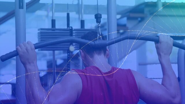 Man pulling wide lat pulldown bar, wearing red sleeveless shirt at gym station showing weight stack