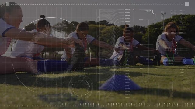 Women players following coach cueing and doing seated fold stretches near blue cone during training