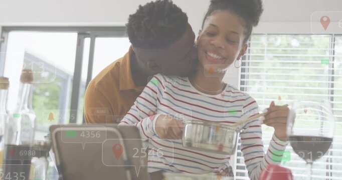 Woman stirring saucepan, man leaning in starting hug, bonding while tech overlay guiding meal prep