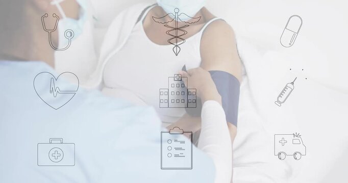 African American female clinician adjusting BP cuff on senior female patient at bedside with icons