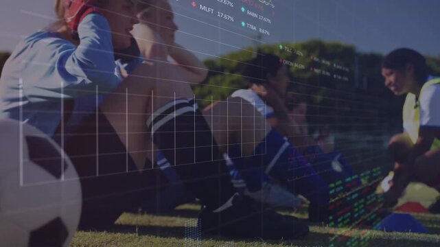 Cam panning right showing soccer ball players doing sit-ups coach cueing data over team for fitness