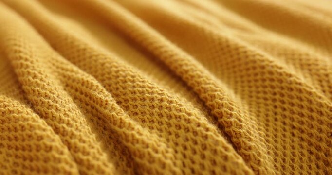 Yellow knitted plaid as background, closeup view
