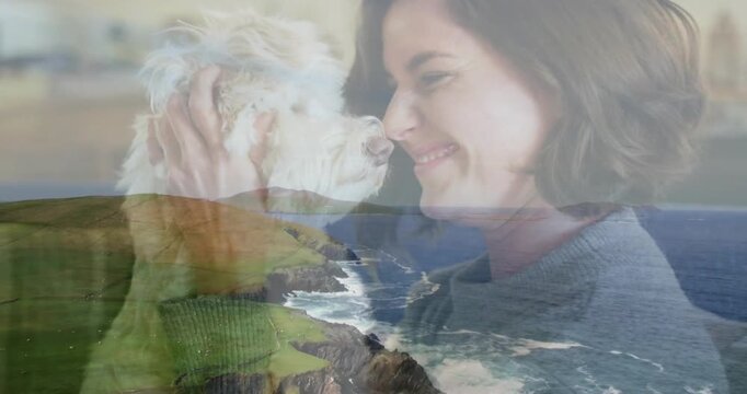 Woman lifting dog in green sweater boosting pet health kissing head transparent coastal lower-third