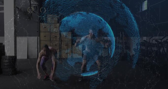 Vertical video: From plank, sleeveless woman and man doing burpees in gym training with blue globe