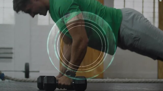 Man starting plank holding hex weights, lowering and rowing, training core, target overlaying torso