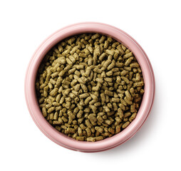 Top view of rabbit food pellets in a pink bowl, isolated on white background