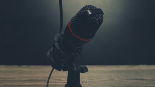 Close up of hand index finger tapping top of black microphone, testing audio equipment connection, soundcheck before broadcast, podcast recording setup, audio gear verification