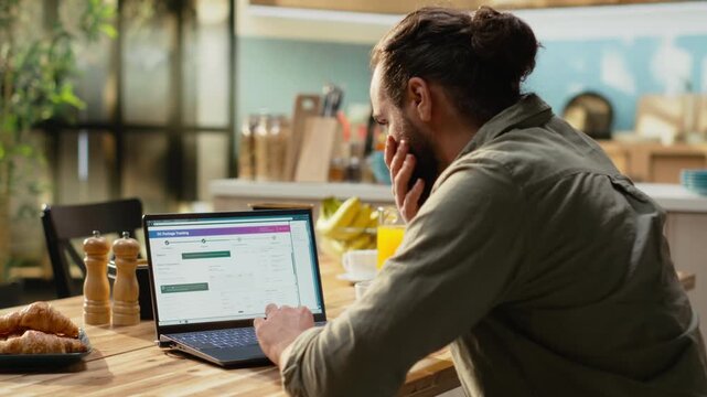 Client using package tracking platform with AWB number on laptop, checking delivery status and reading real time updates on parcel. Tracking number from invoice used for route verification.
