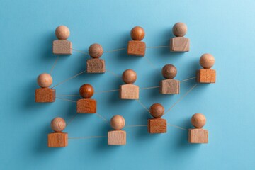 Obraz premium Interconnected Diversity: Wooden figures linked together, illustrating the bonds that tie a community, symbolizing unity and togetherness.