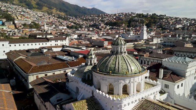 Aerial parallax orbits Iglesia Compa&ntilde;&iacute;a de Jes&uacute;s green ribbed tiled domes revealing Plaza San Francisco and Andean cityscape
