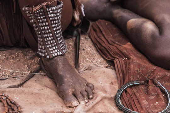 A Himba woman's feet adorned with ankle bracelets, Southern Angola