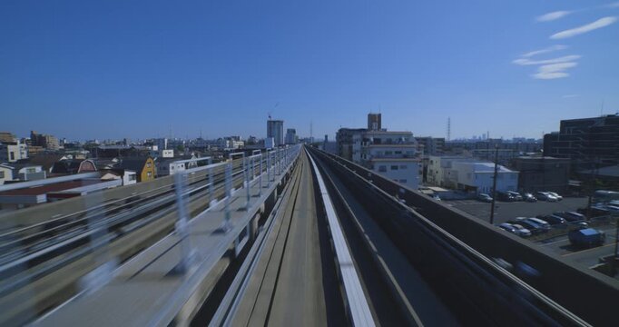 A hyper lapse of a moving backward urban monorail at the downtown in Tokyo by POV
