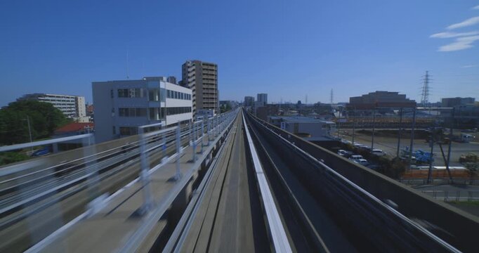 A hyper lapse of a moving backward urban monorail at the downtown in Tokyo by POV