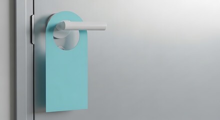 Close-up of a blue door hanger on a white door, indicating privacy and no disturbance.