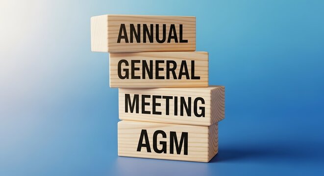 Wooden Blocks with Annual General Meeting AGM Text on Blue