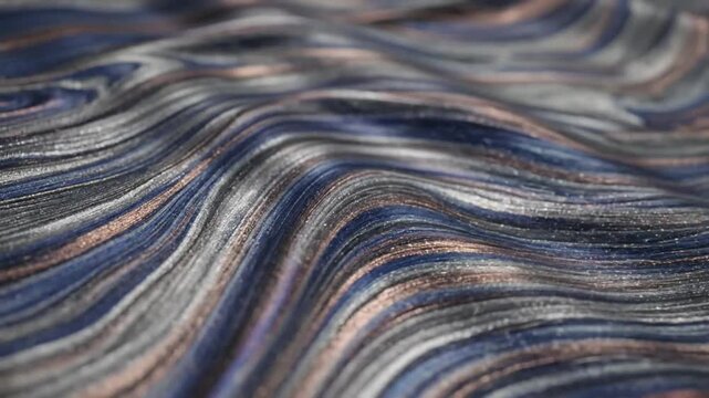 Abstract flowing fabric with silver blue copper streaks in a rippling wave texture