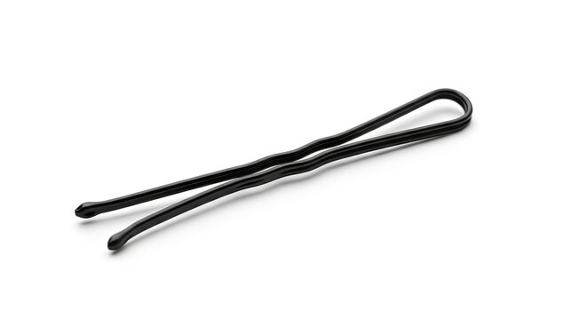 A single black bobby pin is lying on a white background