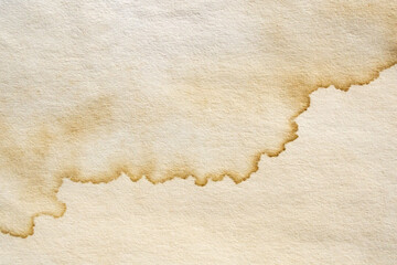 Old vintage paper texture background with aged stains and antique yellowed parchment effect
