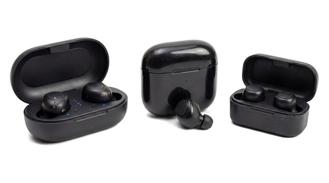 black wireless earbuds and their charging case arranged neatly on a white background, representing modern portable audio and technology.