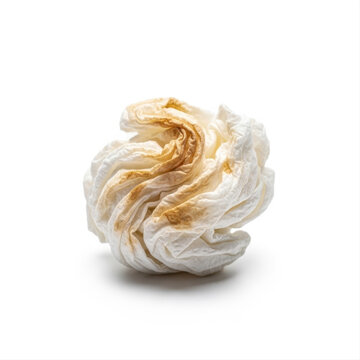 Crumpled stained napkin isolated against a stark white background, showcasing texture and color contrast in a minimalist composition