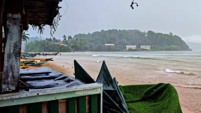 Heavy tropical rain on Indian Ocean during the day in Weligama Beach, Matara District, Southern Province, Sri Lanka, pan shot