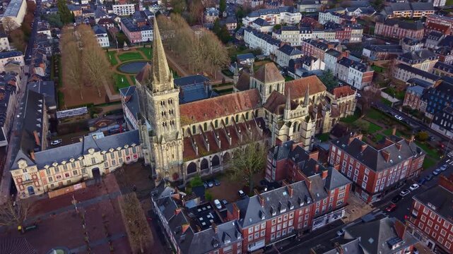 Saint-Pierre Cathedral and the surrounding city square in Lisieux, Normandy. Aerial drone backward