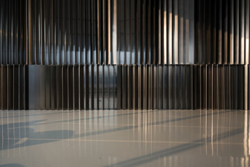 Obraz premium Metallic vertical striped wall with light and shadow reflections on a polished floor surface