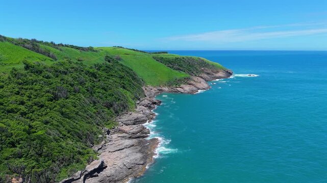 Aerial backdrop of rocky coastline and turquoise ocean at Poca da Tartaruga near Mirante Ponta da Boca da Barra Buzios Brazil
