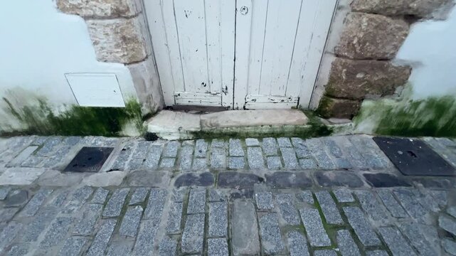 Bottom up view of an ancient door. Mediterranean village. Daylight