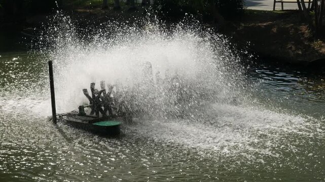 Water aerator turbine fountain creating massive spray for oxygen circulation and wastewater treatment in urban park pond