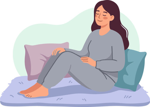 Woman sitting on bed with pillows in a cozy bedroom environment