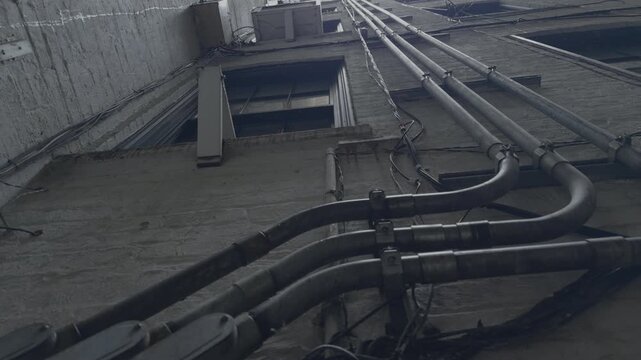 Wet New York Style Facade with Downward Conduit Pipes