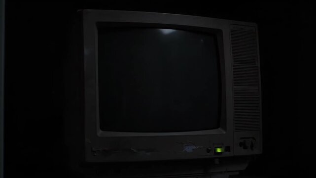 Old computer with a system failure: critical error on screen in the dark.