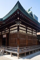 Naklejka premium Historic japanese shinto shrine temple with wooden lattice walls and curved green roof