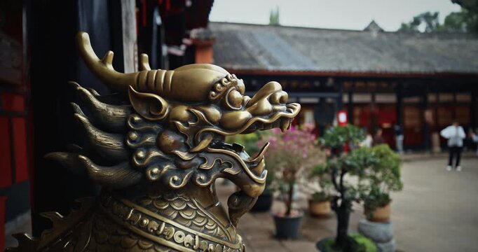 Chengdu, Sichuan, China. Bronze Lion head sculpture. Statue of mystical Chinese guardian lion. Head of golden Lion statue at Wenshu monastery. Sculptures Of Kylins Or Qilin. Kylins Is Mascot Dragon In
