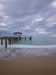 Fototapeta premium rustic industrial pier over the blue sea in a tropical landscape