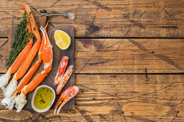 Premium red kamchatka crab legs steamed and cleaned with butter sauce on dark wooden background seafood delicacy © Mironov