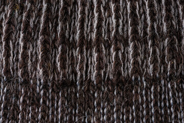 Dark alpaca wool knitted textile macro texture natural fiber background © yalcinsonat