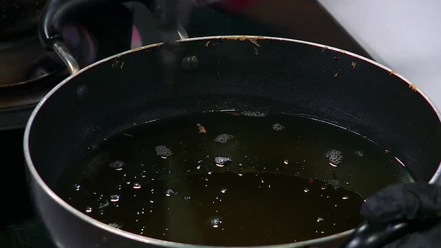 Chef Preheating Cooking Oil to the Perfect Temperature for Deep Frying