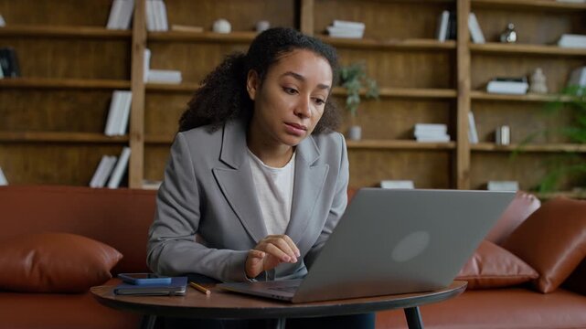 Upset Woman Looking at Laptop After Job Loss