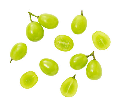 Scattered fresh Shine Muscat green grapes with halves isolated on transparent background