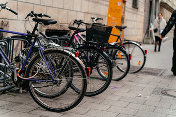 Row of bicycles parked on a city street in an urban European setting. Sustainable transportation and everyday commuting concept highlighting eco friendly lifestyle and modern city mobility.
