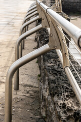 Perspective View of Stainless Steel Railing Along Stone Seawall.