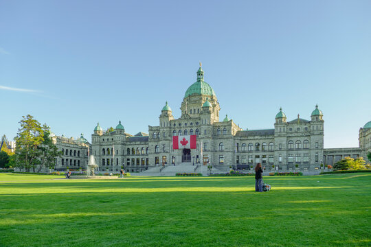 Victoria, BC, Canada: September 9, 2025 - BC Parliament Buildings with Canadian flag on sunny lawn