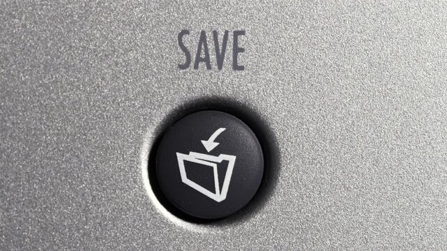 Close up of finger pressing save button on silver control panel